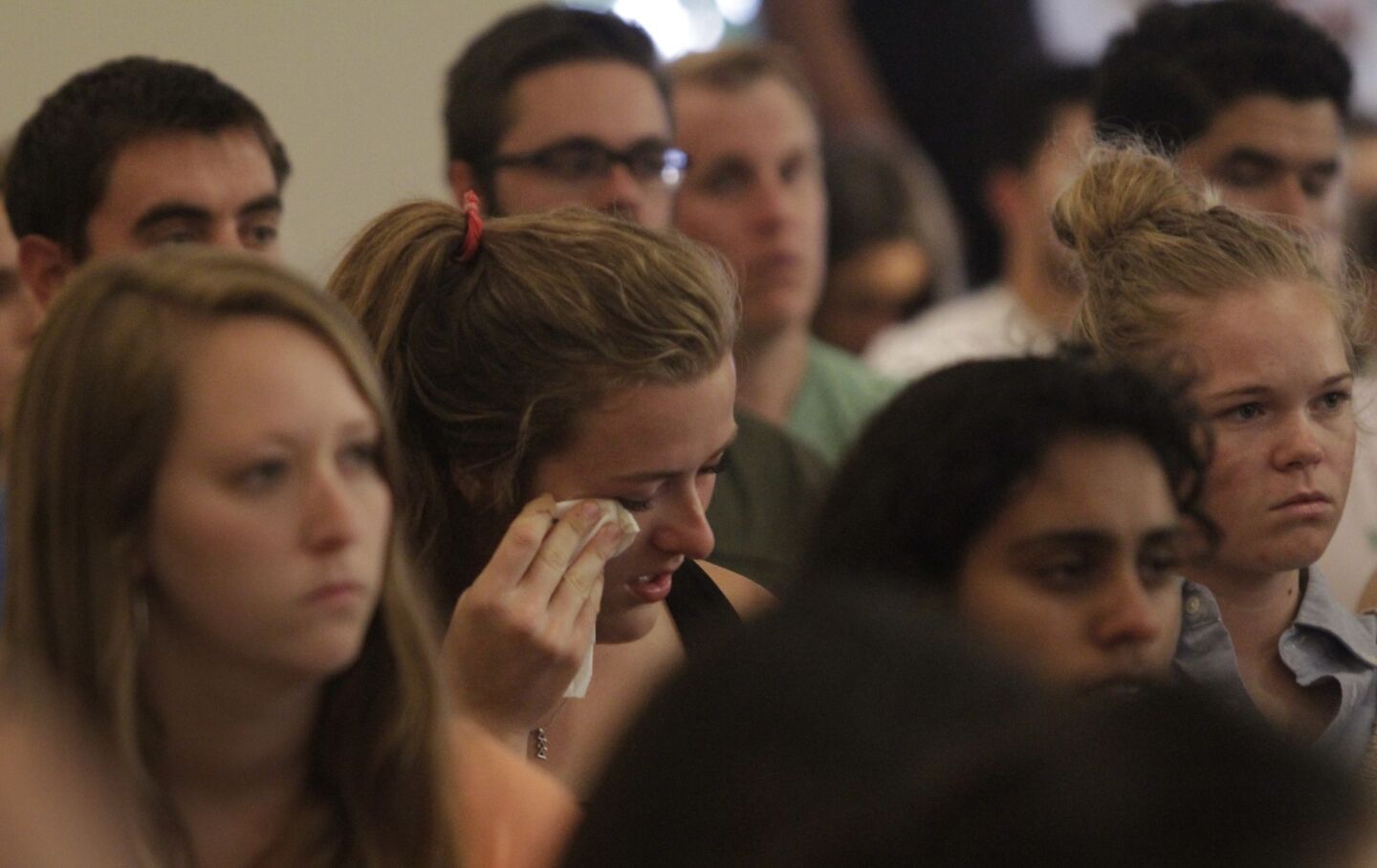 A congregant reacts during Mass at St. Mark's University Parish in honor of the UC Santa Barbara victims.