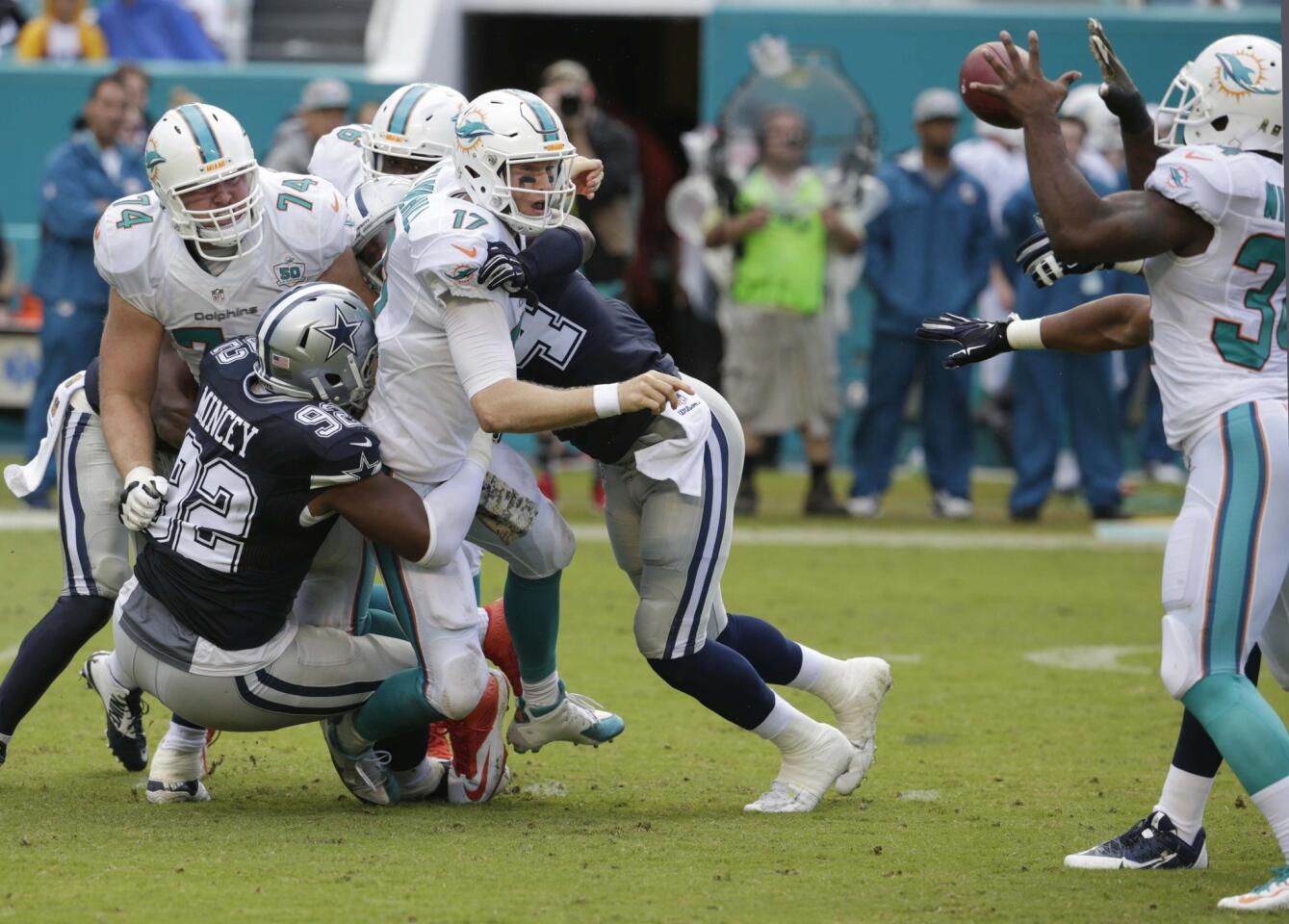 Miami Dolphins quarterback Ryan Tannehill (17) pitches the ball to running back Damien Williams (34) during the first half of an NFL football game against the Dallas Cowboys, Sunday, Nov. 22, 2015, in Miami Gardens, Fla. (AP Photo/Lynne Sladky) ORG XMIT: SLS107
