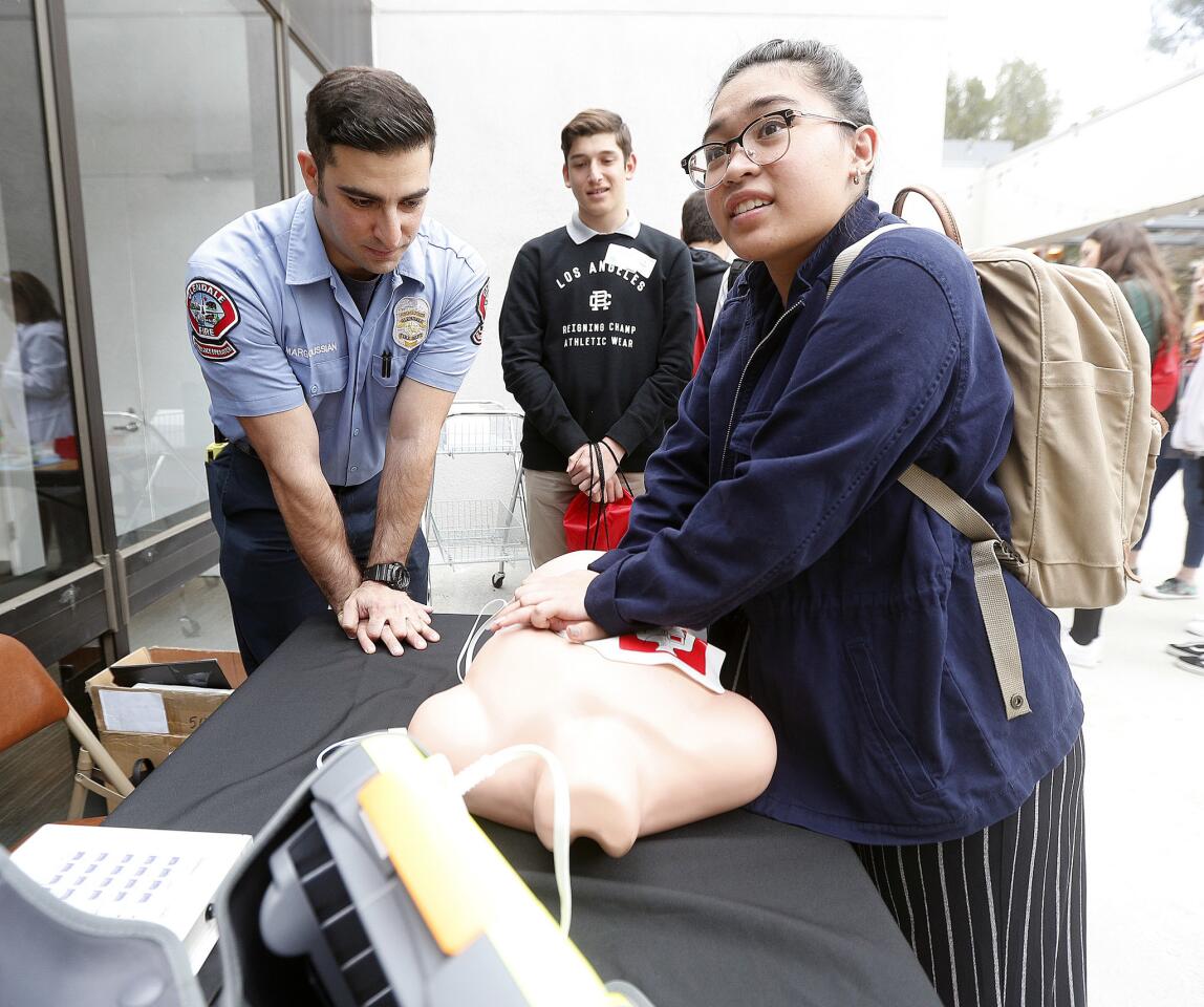 Hannah De Guzman, 15, from Flintridge Sacred Heart Academy, does chest compressions on a dummy torso while Glendale Fire Department Ambulance Operator Vacheh Margoussian shows the correct hand and shoulder position at USC Verdugo Hills Hospital's Day of Discovery job shadow event on Wednesday, March 27, 2019. Fifty high school students from Crescenta Valley, La Canada, St. Francis, Flintridge Sacred Heart Academy, and Eagle Rock interested in working in healthcare learned and had hands-on experience in different aspects of the profession.