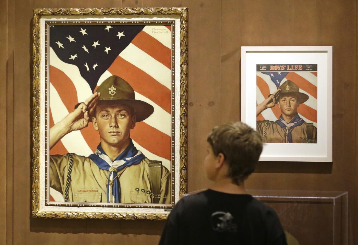 A youth looks over an exhibition in Salt Lake City of works by artist Norman Rockwell. A California bill that would remove tax-exempt status from the Boy Scouts of America for not allowing gay adult leaders was shelved Thursday.