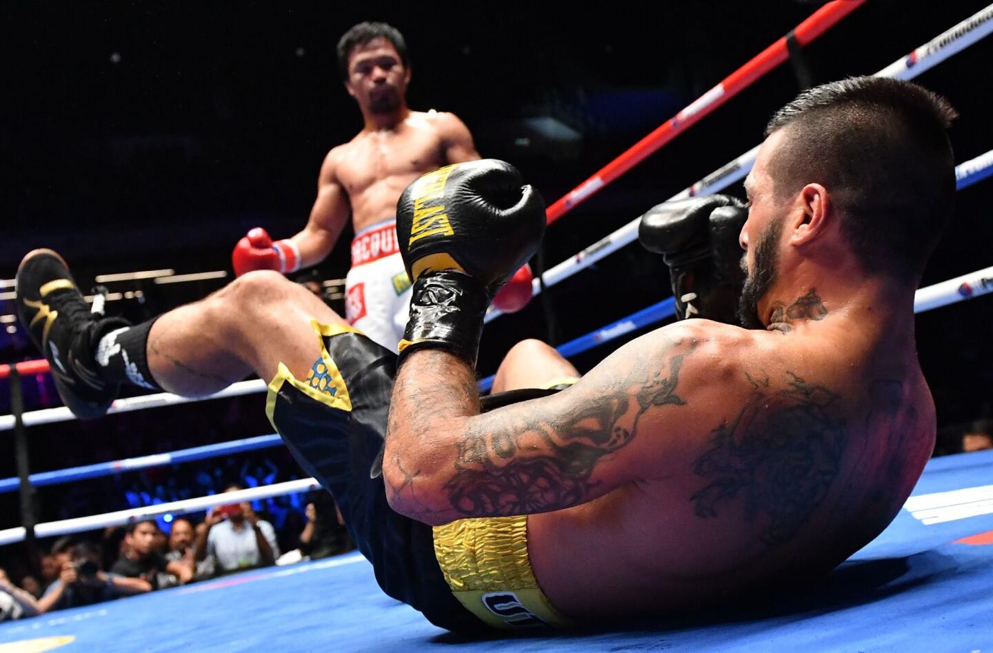 TOPSHOT - Argentina's Lucas Matthysse reacts after he was knocked down by Philippines' Manny Pacquiao during their world welterweight boxing championship bout at Axiata Arena in Kuala Lumpur on July 15, 2018. / AFP PHOTO / Mohd RASFANMOHD RASFAN/AFP/Getty Images ** OUTS - ELSENT, FPG, CM - OUTS * NM, PH, VA if sourced by CT, LA or MoD **