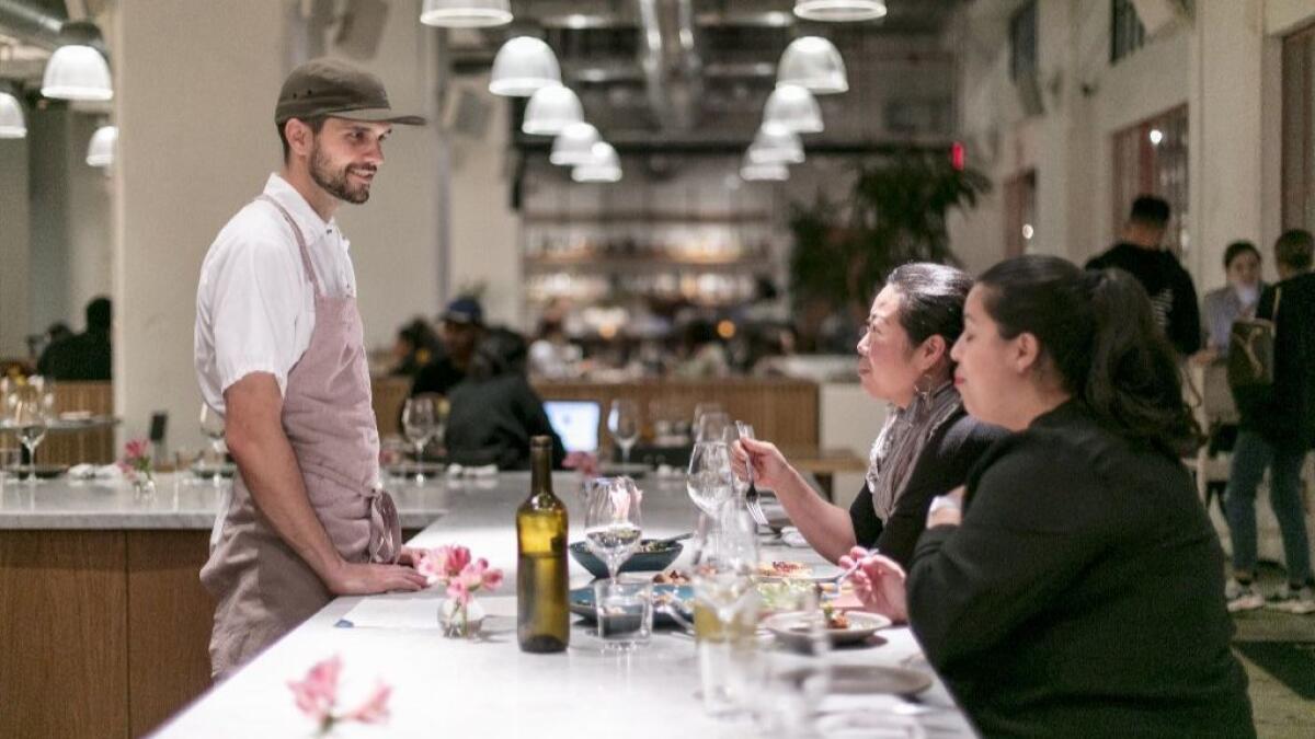 Tartine Bianco Chef de Cuisine Camden Hershberger visits with diners at Tartine's Manufactory.