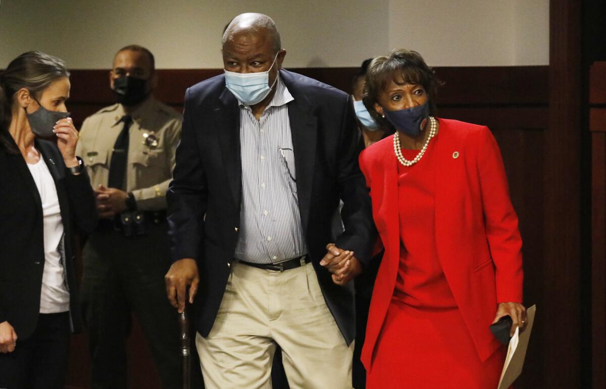 Jackie Lacey and her husband walk while holding hands