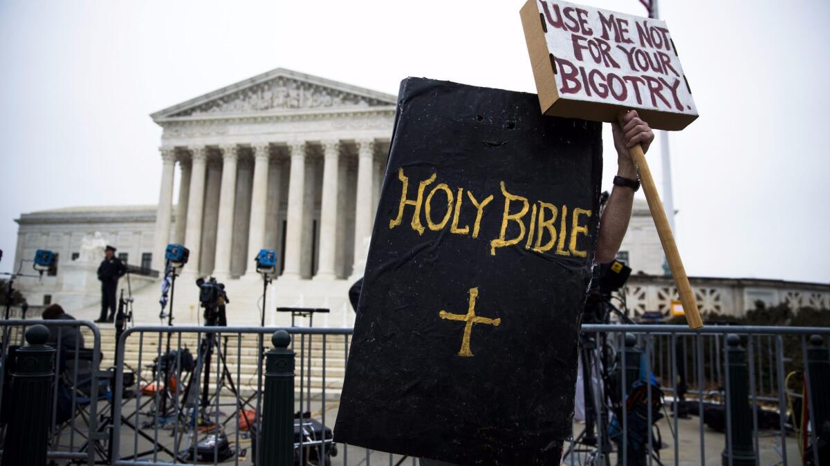 A protester dressed as the Holy Bible rallies against Masterpiece Cakeshop owner Jack Phillips outside the Supreme Court on Dec. 5.