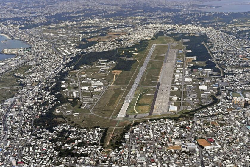 FILE - This Jan. 27, 2018, aerial file photo shows U.S. Marine Air Station Futenma in Ginowan, Okinawa, southern Japan. Okinawan officials said Saturday, July 11, 2020 that dozens of U.S. Marines have been confirmed to have infected with the coronavirus at two bases, Futenma and Camp Hansen, on the southern Japanese island in what is feared to be a massive outbreak, and demanded adequate explanation from the U.S. military officials. (Kyodo News via AP, File)
