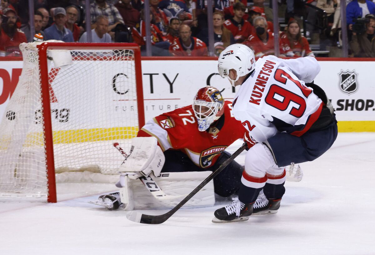 Washington Capitals center Evgeny Kuznetsov (92) scores against Florida Panthers goaltender Sergei Bobrovsky (72) during the third period of Game 1 of an NHL hockey first-round playoff series Tuesday, May 3, 2022, in Sunrise, Fla. (AP Photo/Reinhold Matay)