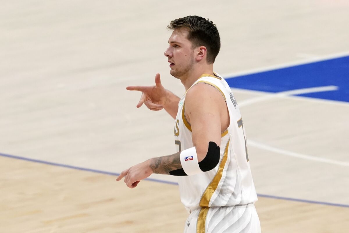 Dallas Mavericks guard Luka Doncic celebrates after sinking a three-point basket in the first half of an NBA basketball game against the Brooklyn Nets in Dallas, Thursday, May 6, 2021. (AP Photo/Tony Gutierrez)