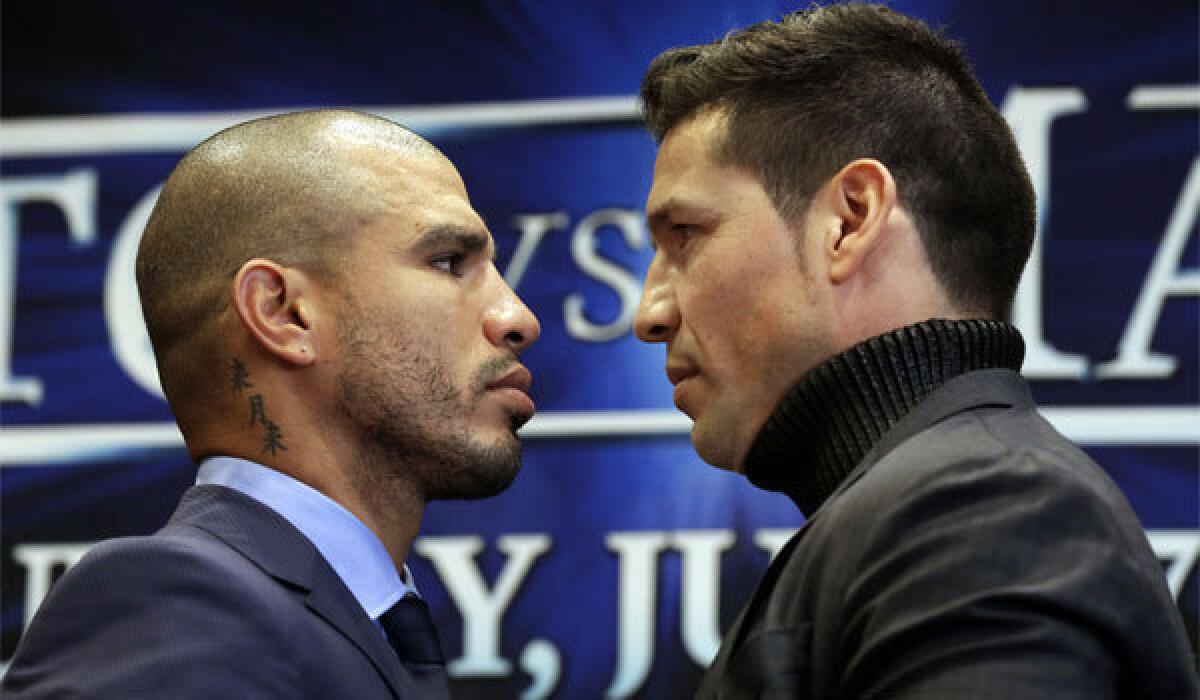 WBC middleweight champion Sergio Martinez, right, and challenger Miguel Cotto face off during a news conference Tuesday in New York's Madison Square Garden.