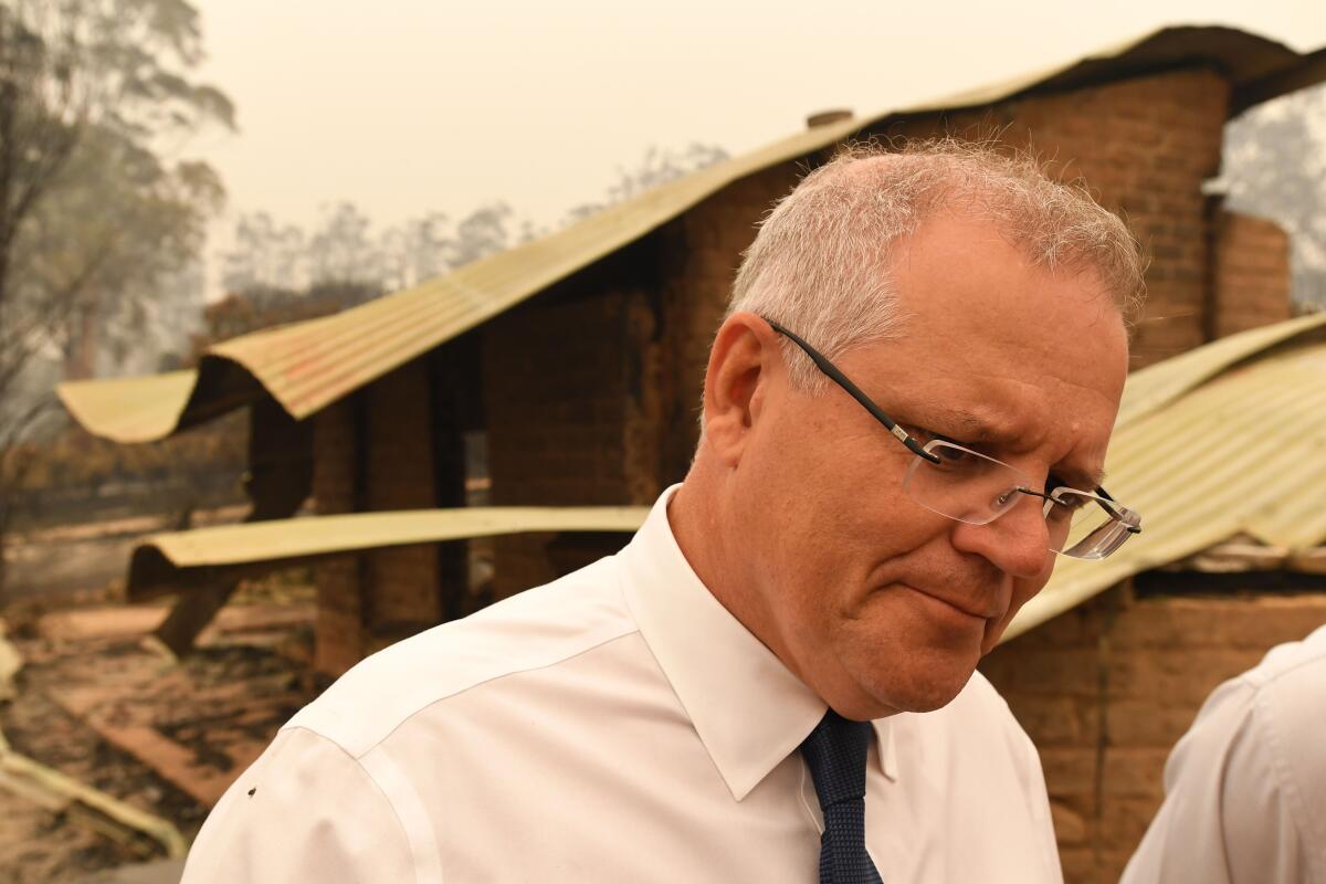 Australian Prime Minister Scott Morrison tours a farm destroyed by wildfire on Jan. 3. 