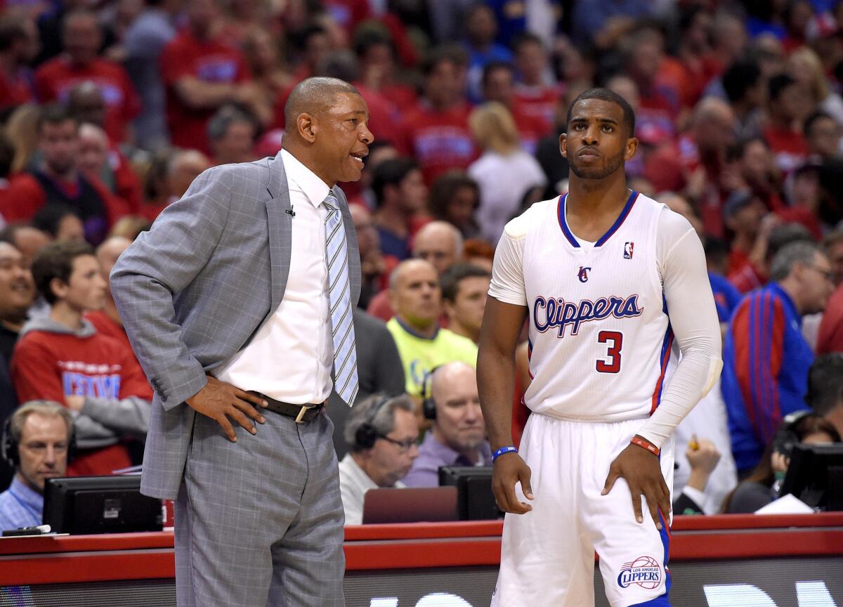 Clippers Coach Doc Rivers talks to point guard Chris Paul during the second half of Game 1 in their playoff series against the Golden State Warriors.