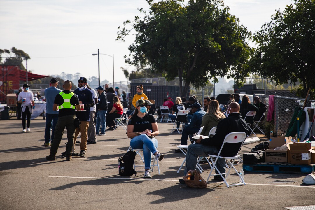 Veterans and escort volunteers eat breakfast on Sunday during the annual “Stand Down” event.