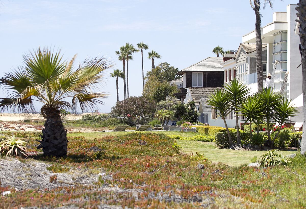 Plants and patio furniture placed on the public beach are examples of encroachments the California Coastal Commission wants removed from the sand in Newport Beach.