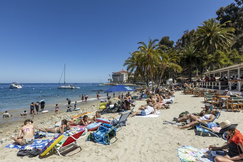 Catalina Island, CA - June 25: Beach-goers relax at the Descanso Beach Club, which features Avalon's only beach side restaurant and bar Friday, June 25, 2021 in Catalina Island, CA. (Allen J. Schaben / Los Angeles Times)