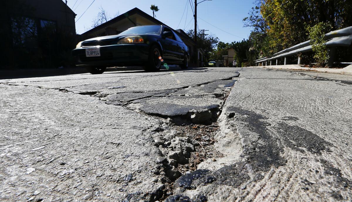 A cracked street in Mount Washington in 2016. Mayor Eric Garcetti is looking to increase a fee charged to utilities for tearing for up city streets, with proceeds going to pay for repairs.