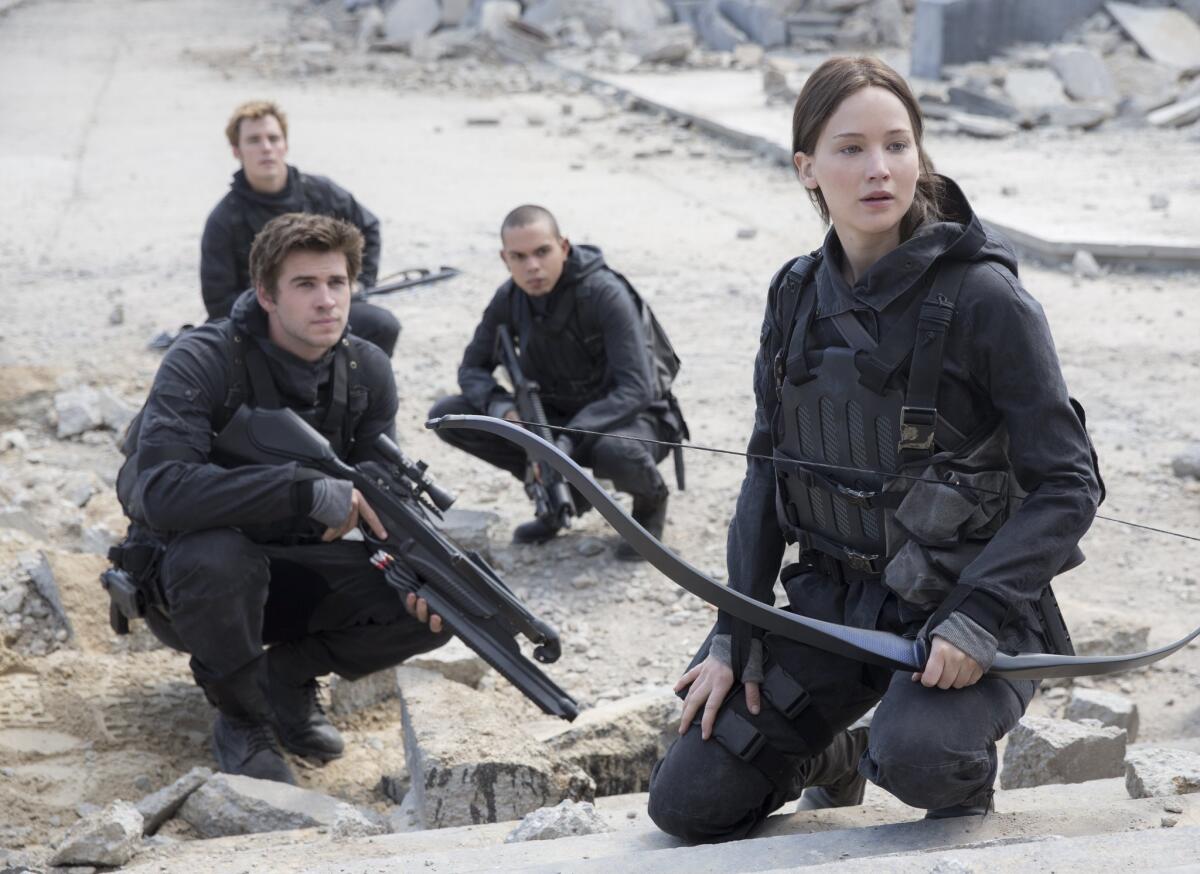 From left, Liam Hemsworth, Sam Claflin, Evan Ross and Jennifer Lawrence take on the Capitol in "The Hunger Games: Mockingjay -- Part 2."