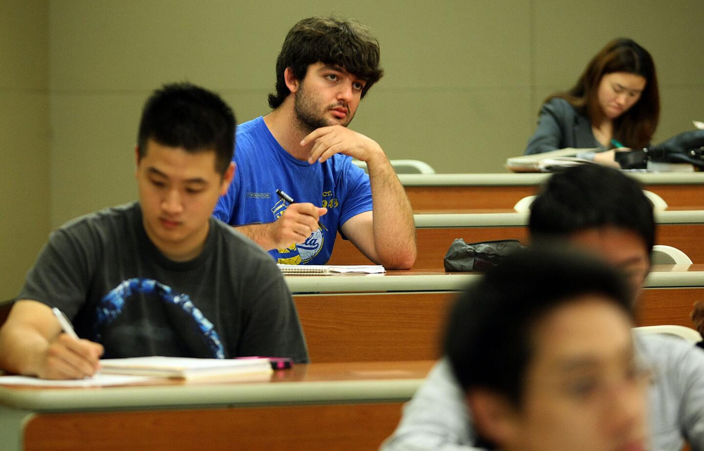 Philip Caltabiano listens to the instructor in a UCLA physics class. He studied marine biology and conservation biology and hopes to get a field research position after graduating next month. He has also applied to be a teaching assistant at UCLA. He has $14,500 left in student debt; he has already paid back $7,000.