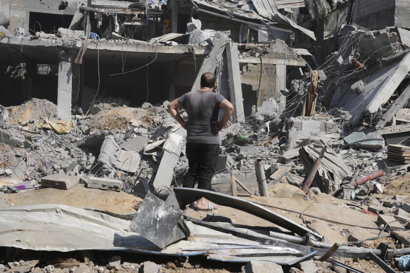 Palestinians look at destruction by the Israeli bombardment of the Gaza Strip in the Maghazi refugee camp, in Deir Al-Balah, Wednesday, Oct. 25, 2023. ( AP Photo/Hatem Moussa)