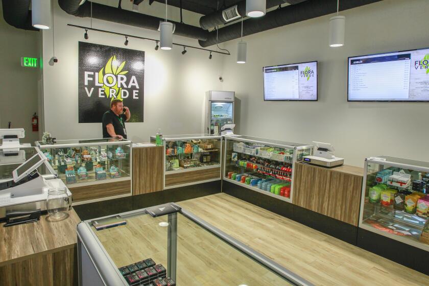 Co-owner Jake Christman works at Flora Verde marijuana dispensary on November 6, 2019 in Vista, California.