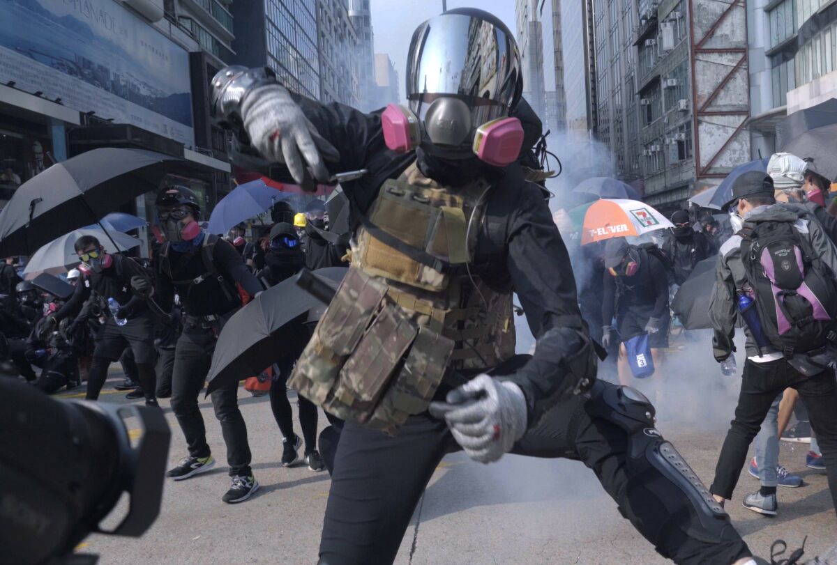 A protester wears a gas mask and military gear in the documentary “Revolution of Our Times.”