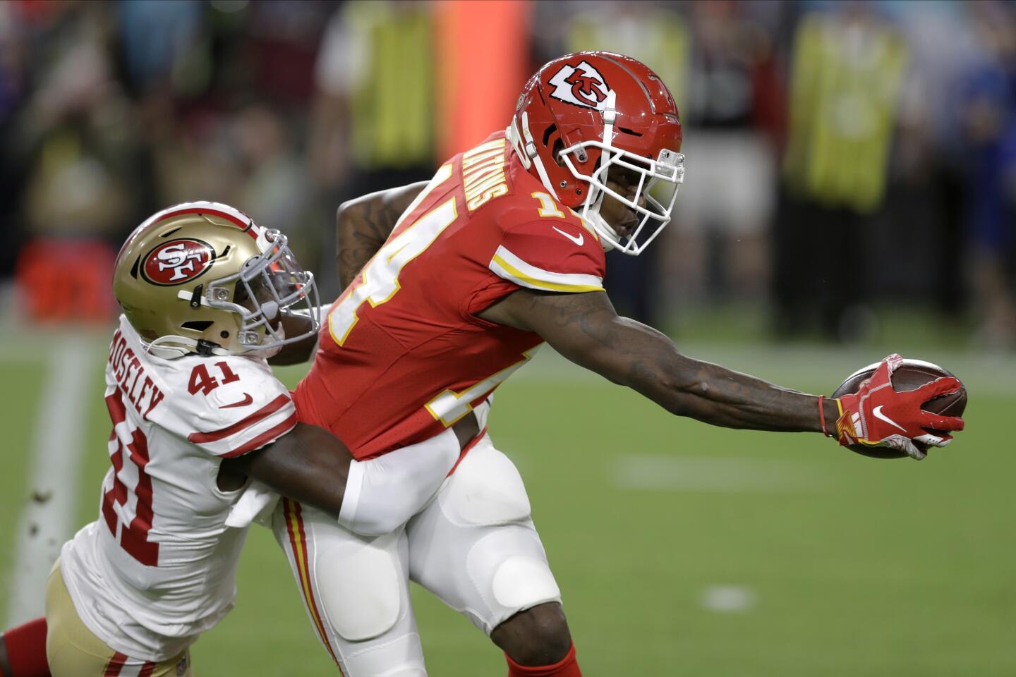 San Francisco 49ers defensive back Emmanuel Moseley, left, tackles Kansas City Chiefs wide receiver Sammy Watkins during the first half.