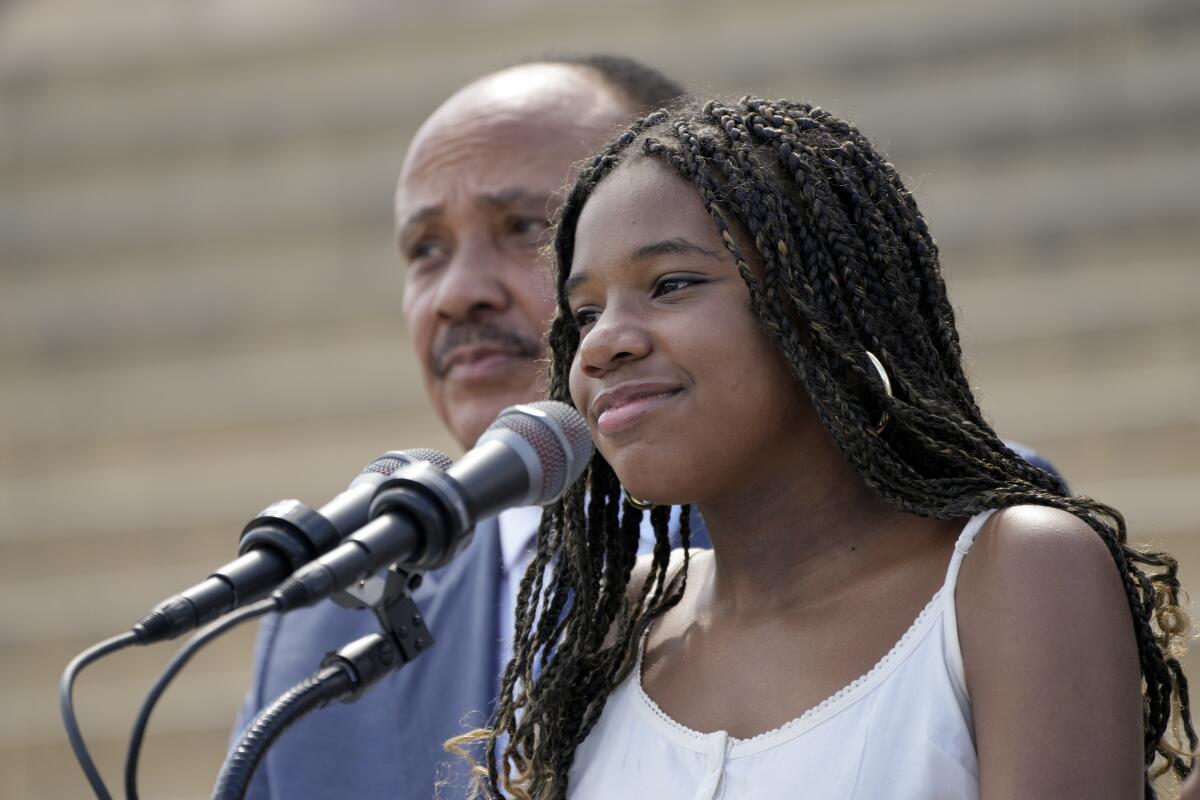 Yolanda King speaks as her father, Martin Luther King III, listens at the Lincoln Memorial.