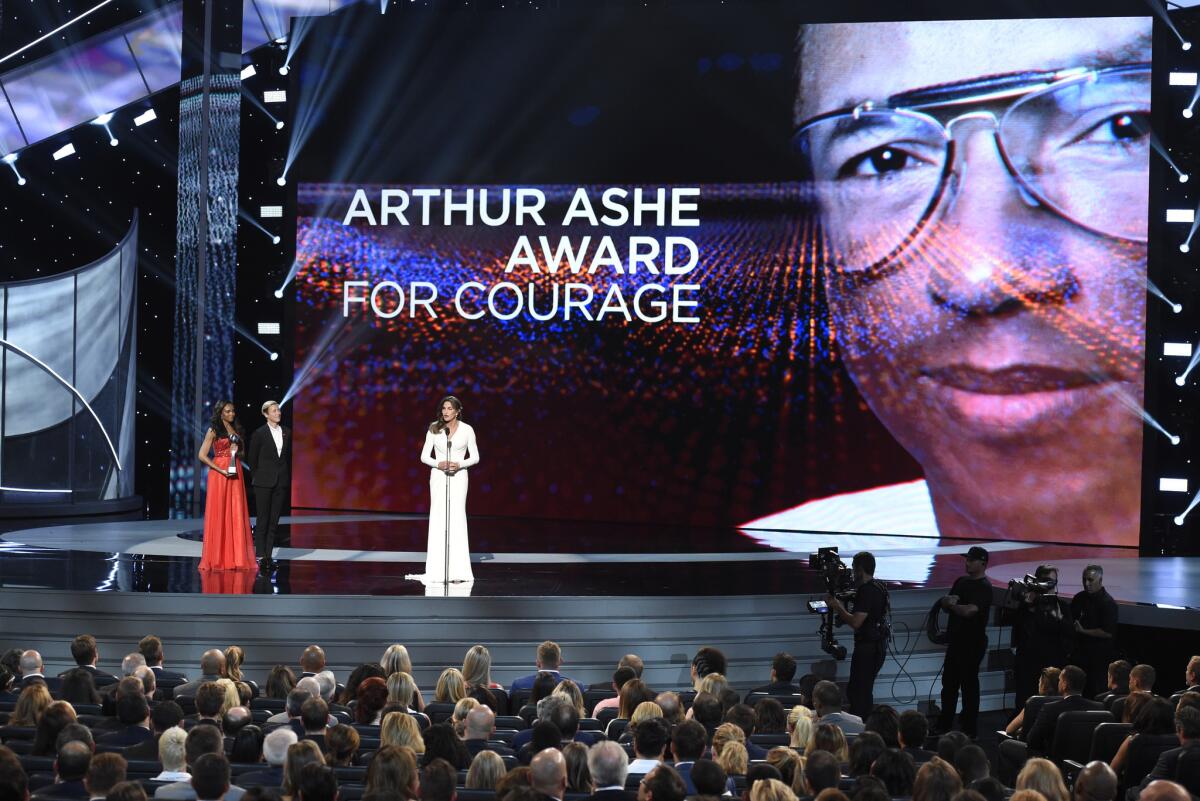 Abby Wambach of the U.S. women's national soccer team, second left, presents Caitlyn Jenner with the Arthur Ashe Award for Courage at the ESPYs at the Microsoft Theater in Los Angeles on July 15.