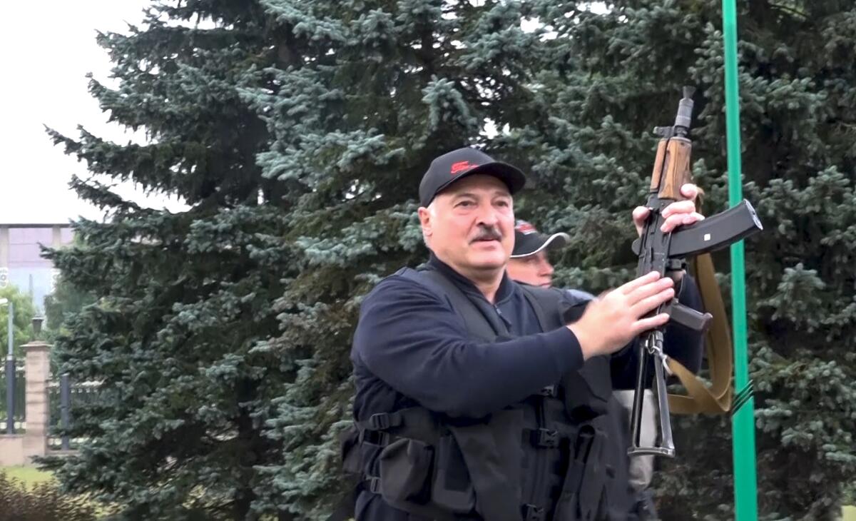 Belarus President Alexander Lukashenko holds a rifle near the Palace of Independence in Minsk, Belarus, on Aug. 23. 