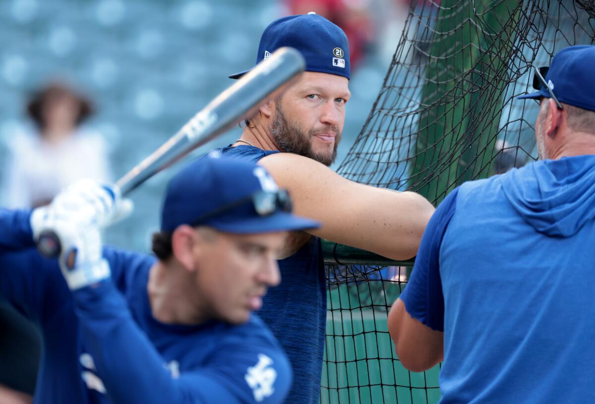 Dodgers pitcher Clayton Kershaw talks during batting practice before a game at Angel Stadium.