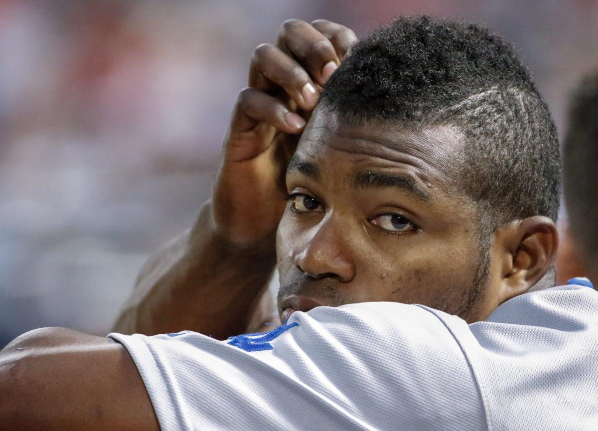 Dodgers outfielder Yasiel Puig watches from the dugout against the Atlanta Braves on July 21.