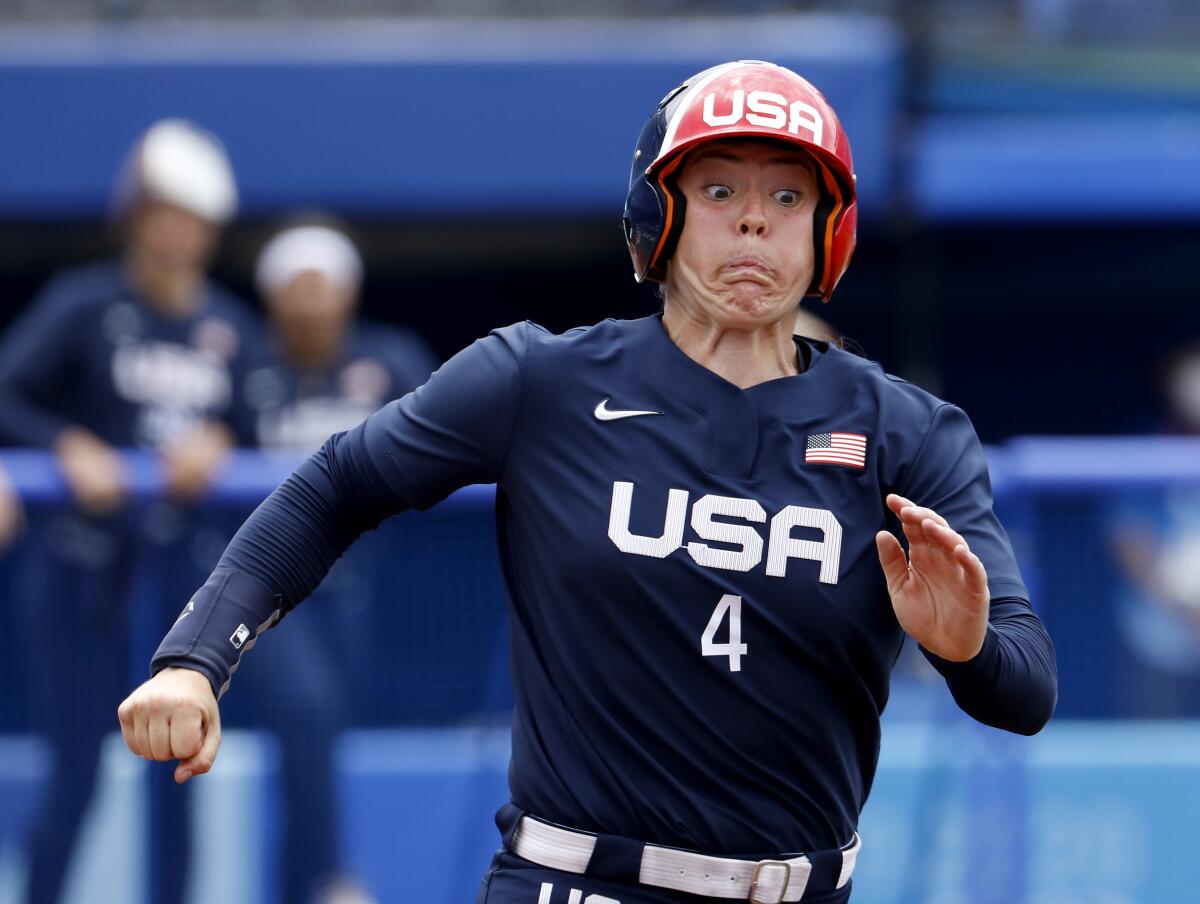 U.S. player Amanda Chidester strains as she runs to first base against Japan on Monday.