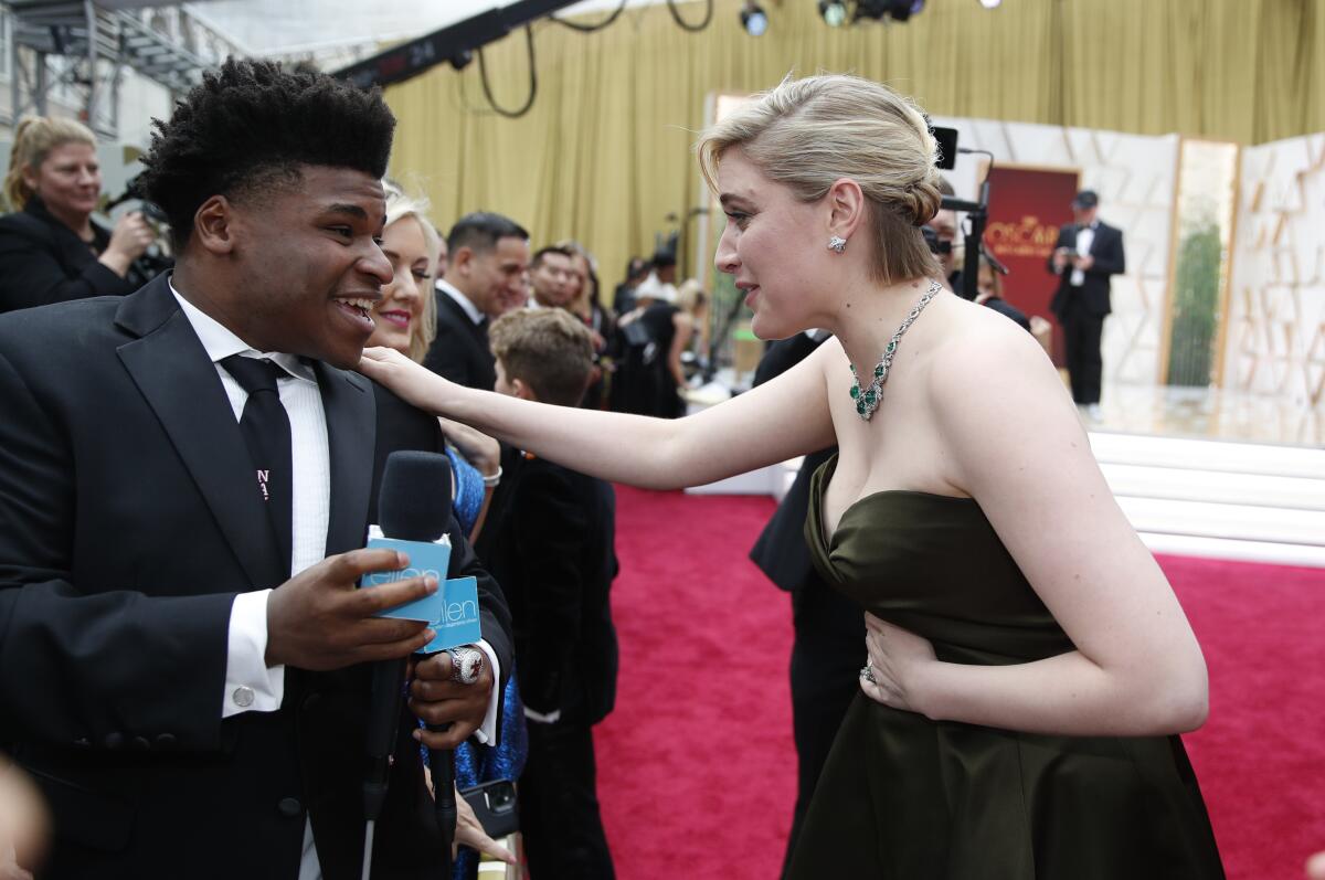 Greta Gerwig, right, talks to Jerry Harris on the red carpet at the Oscars in February 2020.