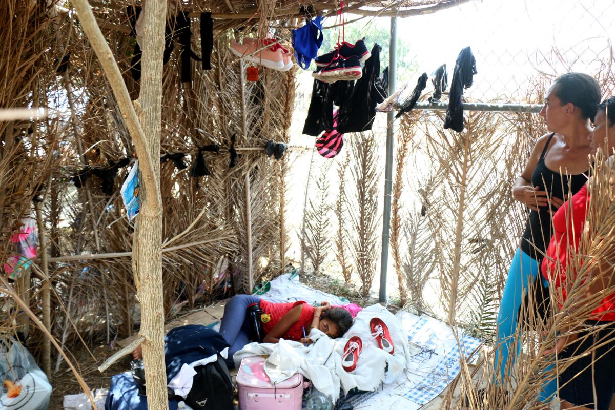 Migrants take shelter at a makeshift dwelling in a sports field in Mapastepec Mexico.