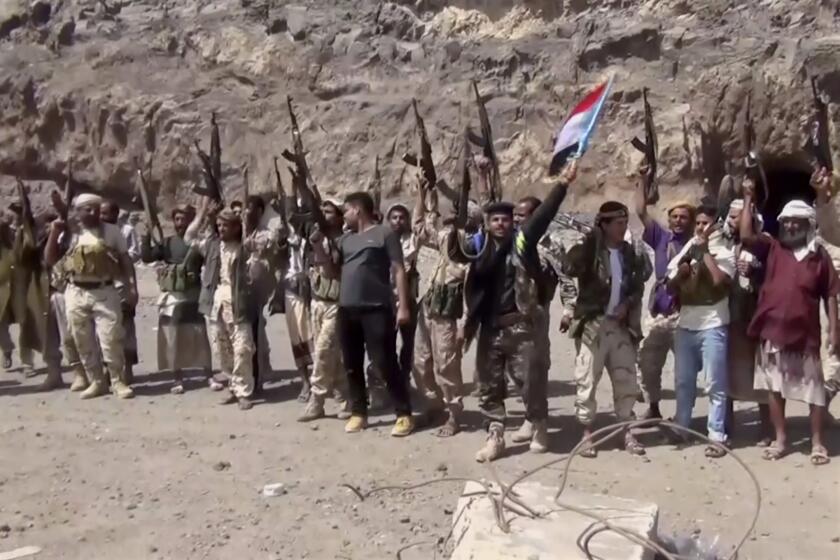 FILE - This Jan. 30, 2018, file image made from a video shows fighters loyal to the separatist so-called Southern Transitional Council, backed by the United Arab Emirates, chanting after taking control of Mount Hadid in Aden which was controlled by forces loyal to President Abed Rabbo Mansour Hadi, in Aden Yemen. Yemen’s leading separatist group will abandon its aspirations for self-rule to implement a stalled peace deal brokered by Saudi Arabia, it announced early Wednesday, July 29, 2020 in a major step toward closing a dangerous rift between nominal allies in the chaotic proxy war. (AP Photo)