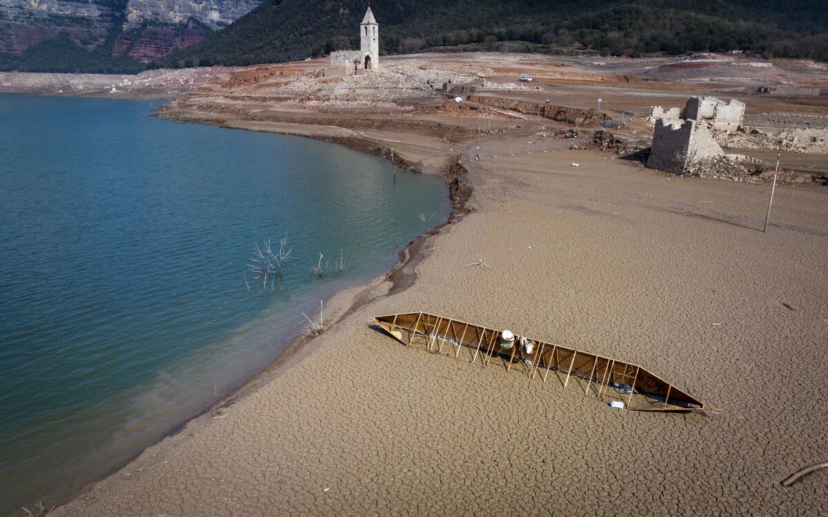 View of the Sau reservoir, about 100 km (62 miles) north of Barcelona. Spain, Monday, March 20, 2023. The Sau reservoir's water levels now stand at 9% of total capacity, according to Catalan Water Agency data, so officials have taken the decision to remove its fish to prevent them from asphyxiating. (AP Photo/Emilio Morenatti)