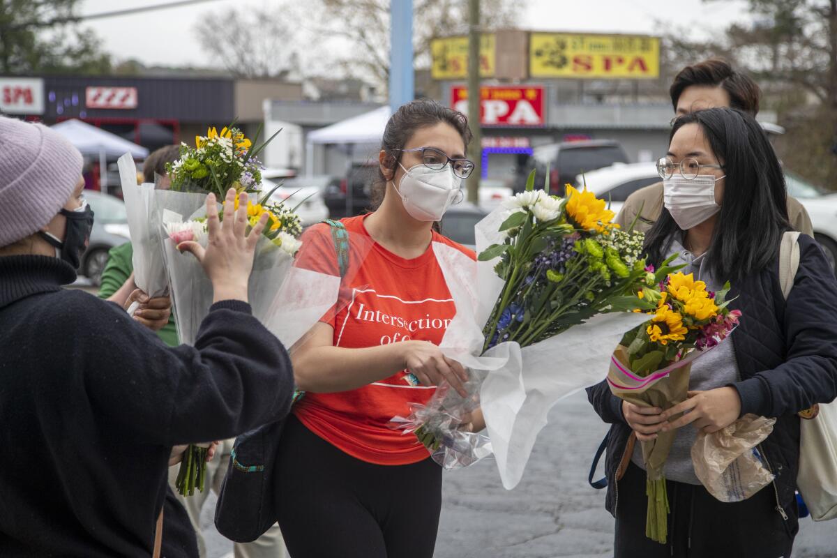 Women with bouquets of flowers. 