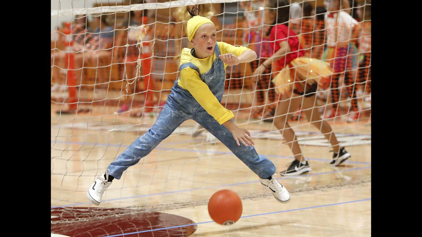 A member of the Minions team gets out of the way of a flying ball during the 8th annual Laguna Beach SchoolPower Dodgeball tournament on Wednesday.