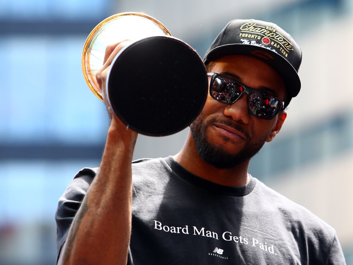 Kawhi Leonard holds the NBA Finals MVP trophy during the Raptors' victory parade on June 17, 2019, in Toronto.