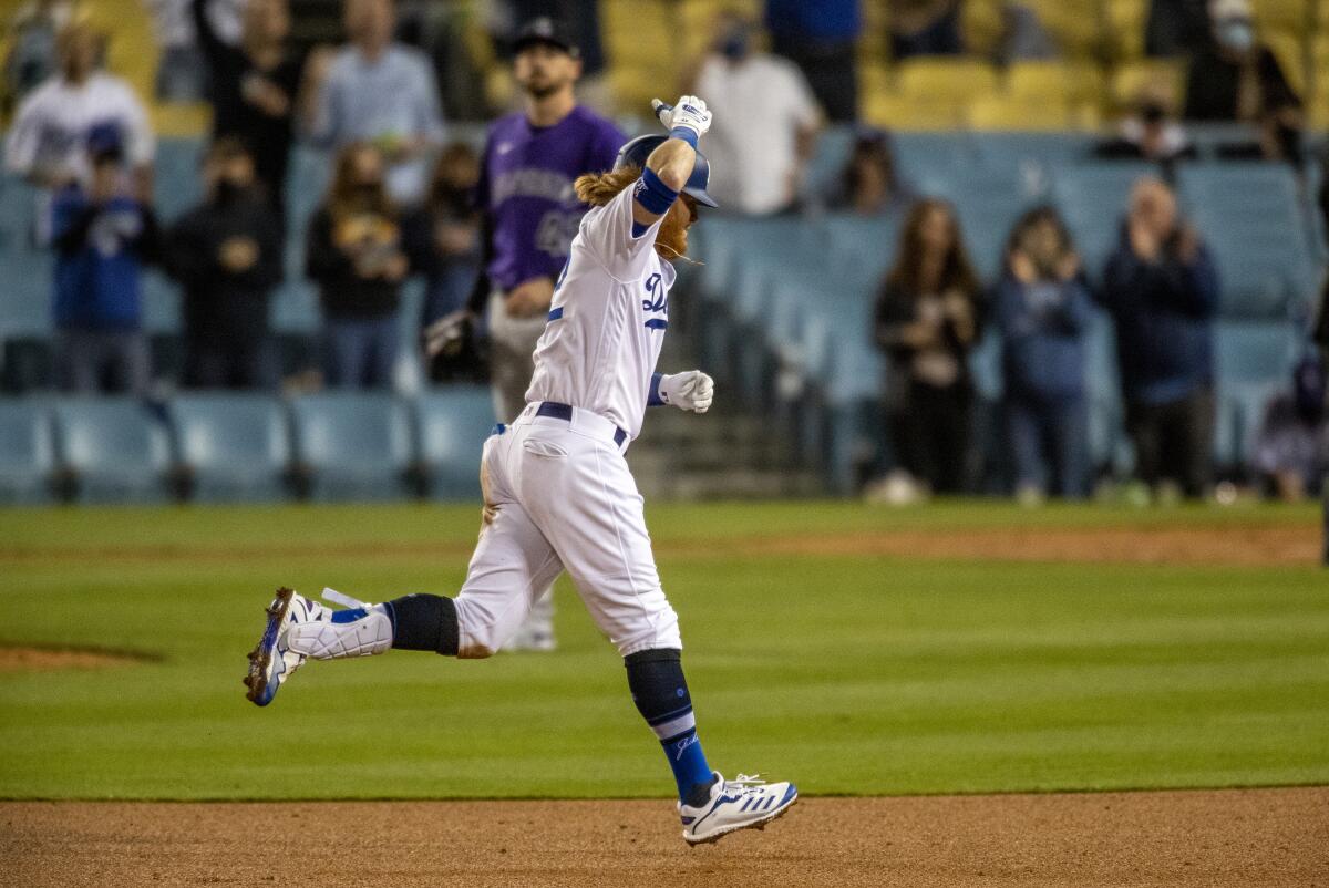 Dodgers third baseman Justin Turner rounds the bases after hitting a three-run home run.