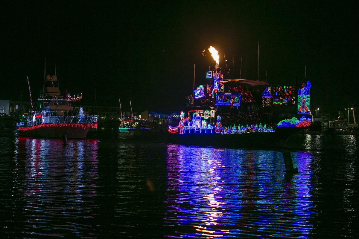Boats pass Marina Park during the opening day of the 114th Newport Beach Christmas Boat Parade.