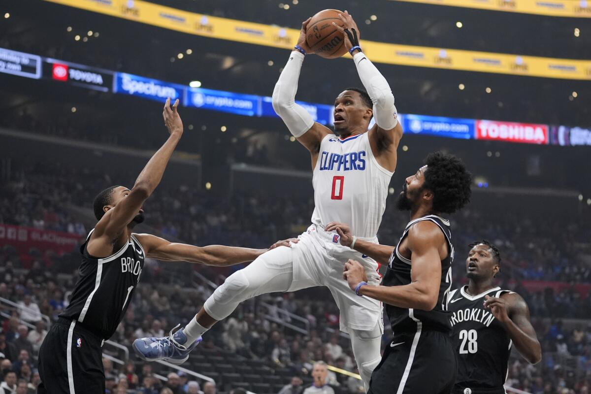 Clippers guard Russell Westbrook (0) pulls up for a shot in the lane against the Nets on Sunday.