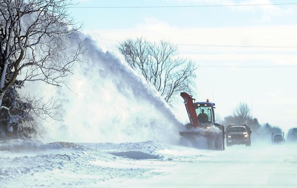 A large snowblower clears drifts from a highway near Mapleton, Minn., last week.