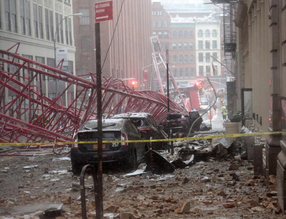 A collapsed crane lies on the street early Friday in NYC.
