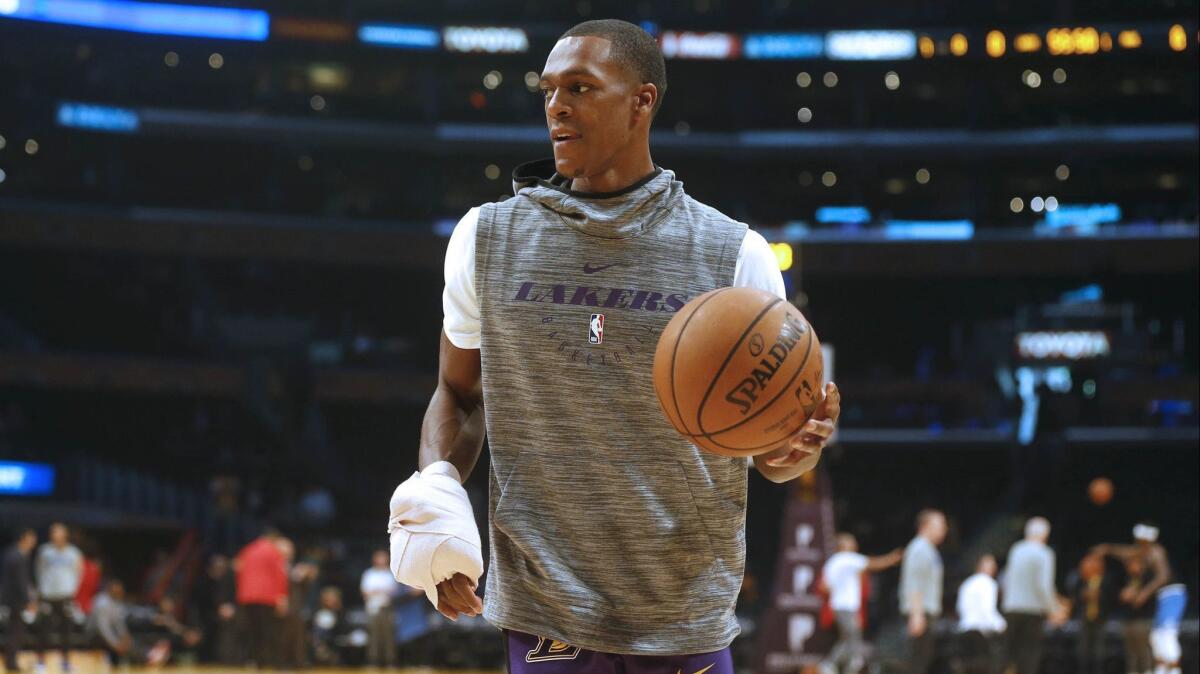 Lakers guard Rajon Rondo (9), out of the lineup with a broken hand that required surgery, warming up before the start of a game against the Orlando Magic on Nov. 25.
