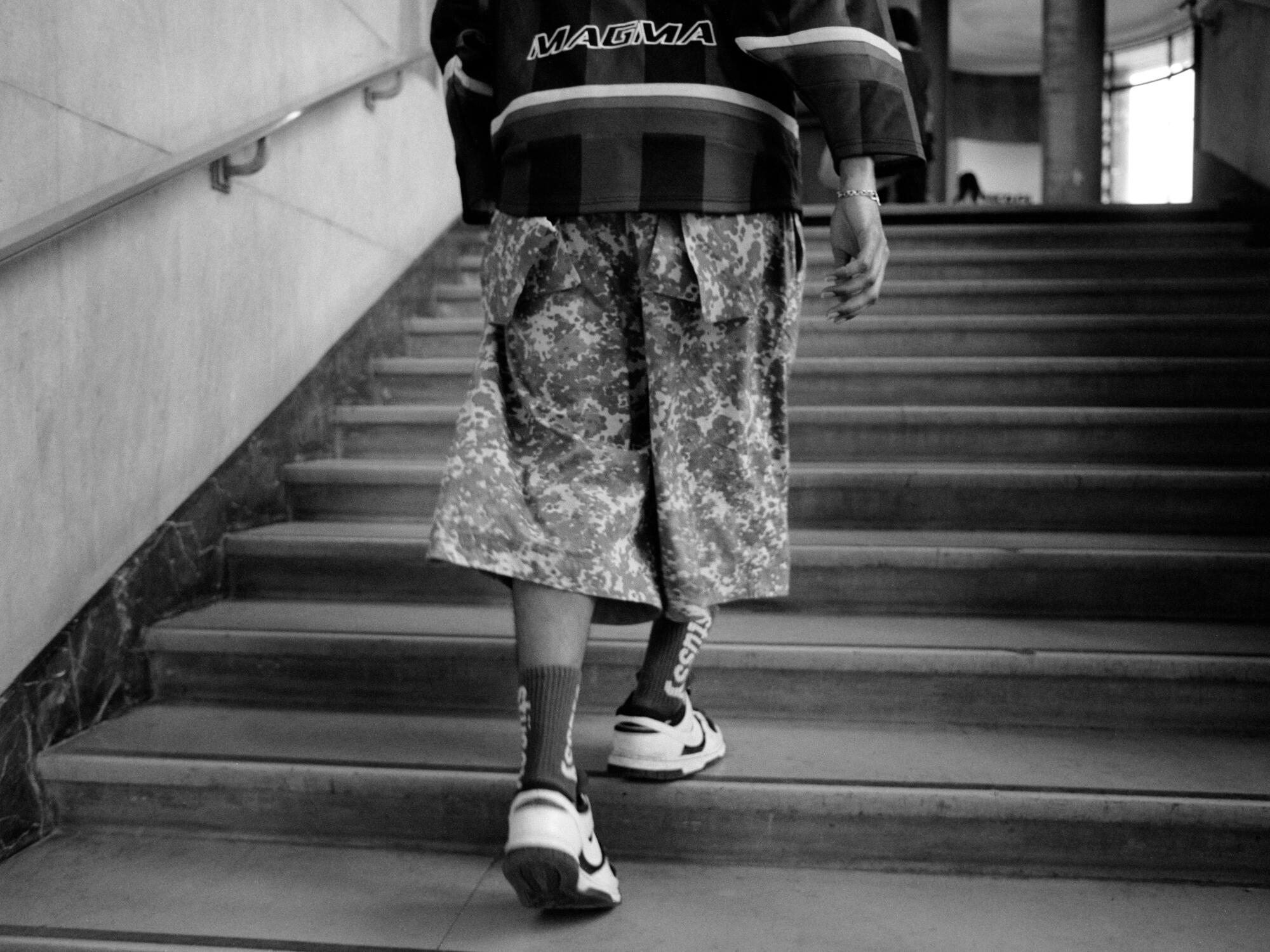 A black and white photo of Colombo walking.