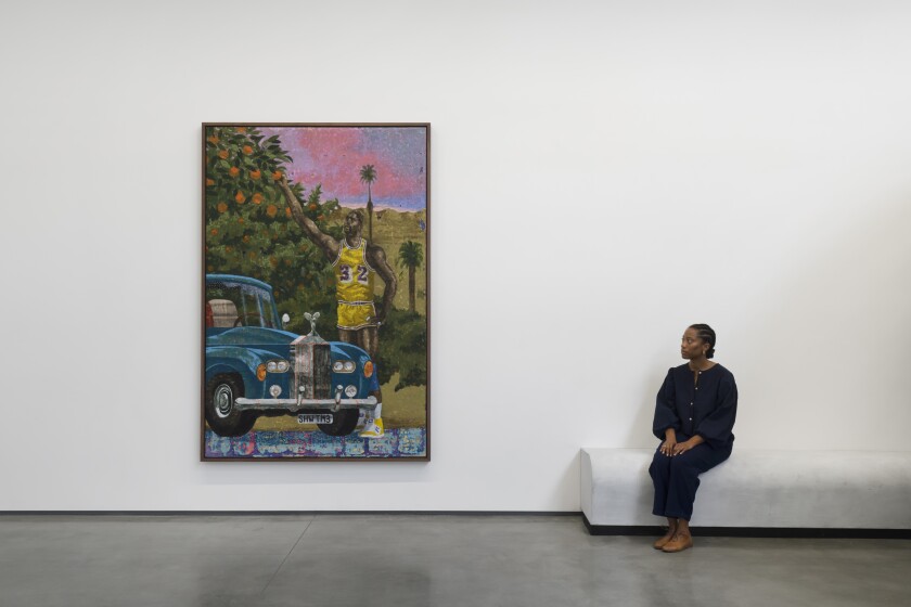A gallerygoer sits next to a painting.