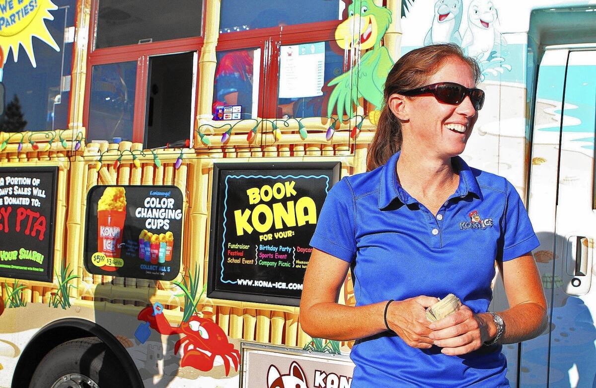 Tamar Hill, the former girls basketball coach at La Canada High School and new owner of a Kona Ice shave ice truck, talks with friends at the Paradise Canyon Elementary back to school night in La Cañada Flintridge on Friday, August 22, 2014.