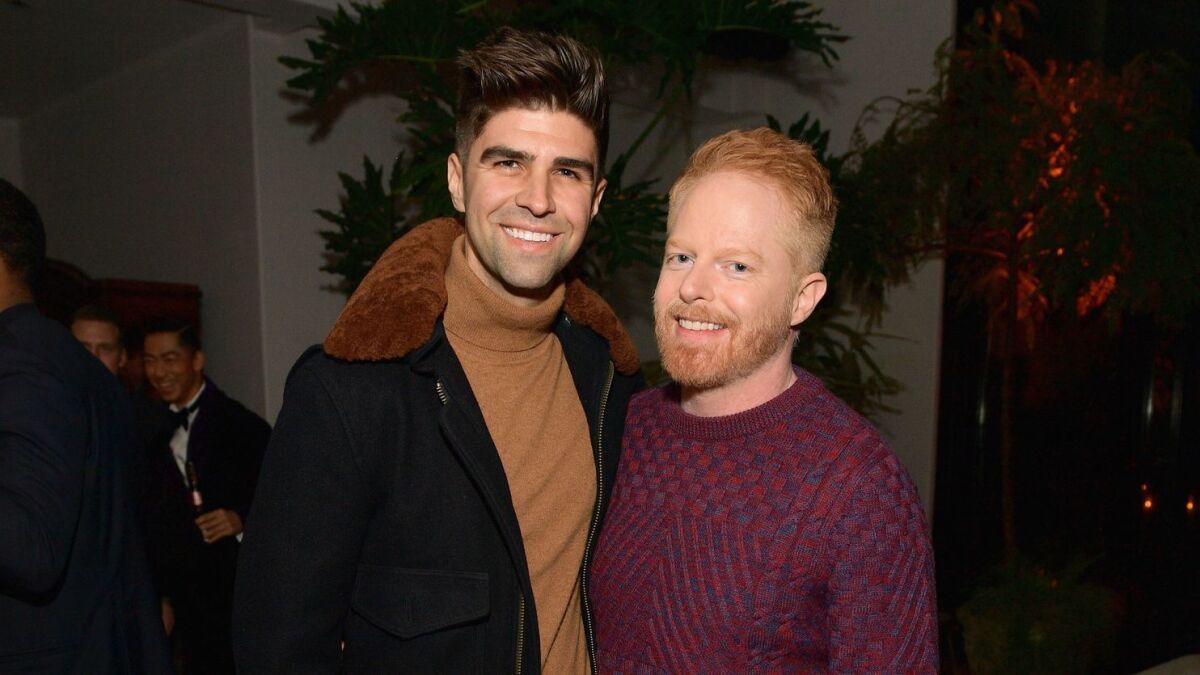 Justin Mikita, left, and Jesse Tyler Ferguson at the 2018 GQ Men of the Year Party.