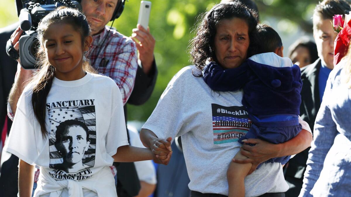 Jeanette Vizguerra, center, leaves the downtown Denver church where she lived the last three months to avoid immigration authorities.