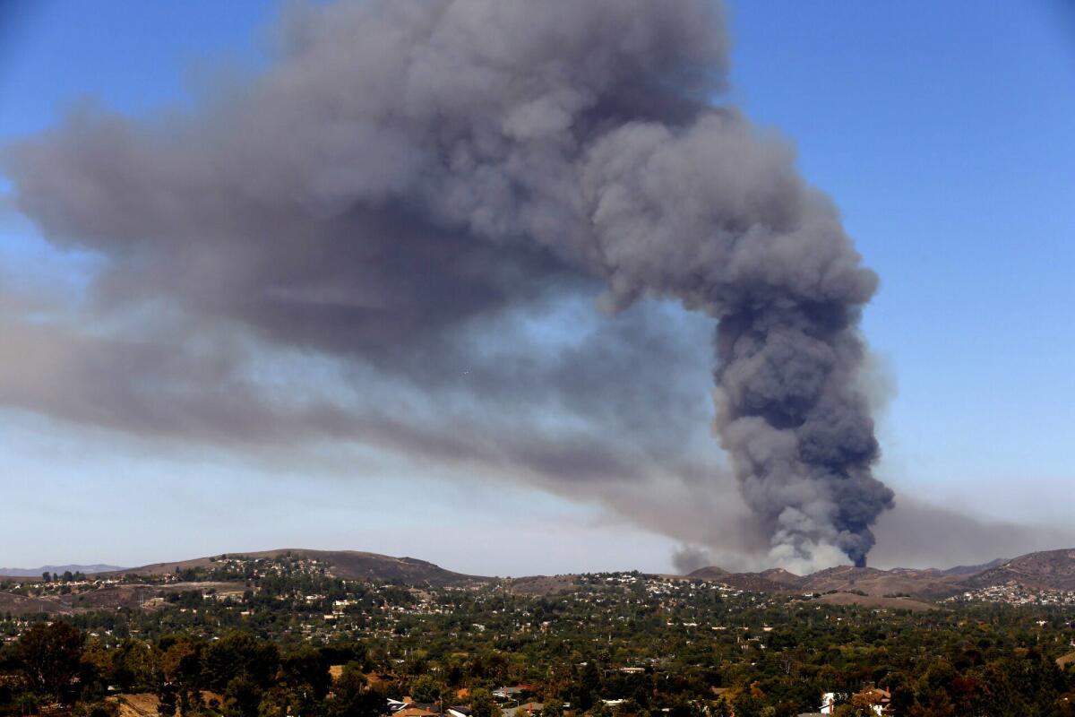 Brush fire puts up a huge plume of smoke in the hills above Simi Valley.