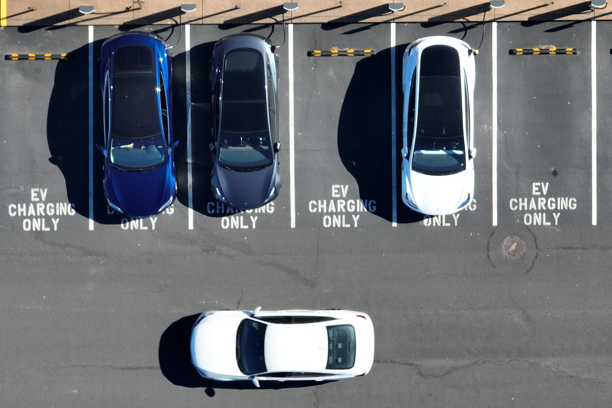 A overhead photo of four cars in a parking area.